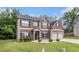Inviting two-story home featuring a brick facade, two-car garage, and manicured front lawn at 3225 Rex Ridge Dr, Rex, GA 30273