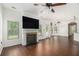 Bright living room showcasing a fireplace, hardwood floors, and natural light from windows at 3225 Rex Ridge Dr, Rex, GA 30273