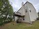 Back exterior view featuring a small wood deck and vinyl siding at 1822 Millwood Park Ct, Buford, GA 30518