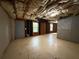 Unfinished basement with exposed insulation and a door to the outside at 1822 Millwood Park Ct, Buford, GA 30518