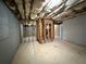 Unfinished basement with concrete floors and exposed insulation at 1822 Millwood Park Ct, Buford, GA 30518