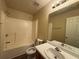 Bathroom with bathtub, toilet, vanity, and a large mirror at 1822 Millwood Park Ct, Buford, GA 30518