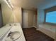 Bathroom with dual sinks, bathtub and vinyl flooring at 1822 Millwood Park Ct, Buford, GA 30518