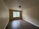 Bedroom featuring hardwood floors, one window, and beige walls at 1822 Millwood Park Ct, Buford, GA 30518