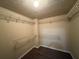 Spacious walk-in closet featuring hardwood floors and multiple wire shelves for storage at 1822 Millwood Park Ct, Buford, GA 30518