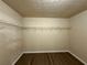 Walk-in closet featuring hardwood floors and wire shelving at 1822 Millwood Park Ct, Buford, GA 30518