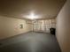 Spacious two-car garage featuring a painted floor and a sectional garage door at 1822 Millwood Park Ct, Buford, GA 30518