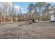 Large backyard with an old storage shed surrounded by mature trees, offering a rustic charm at 2248 Bethel Rd, Conyers, GA 30012