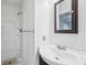 Bathroom featuring a white vanity, square mirror, and a shower stall with glass doors at 2248 Bethel Rd, Conyers, GA 30012