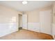 Neutral bedroom featuring paneled walls, neutral paint, door to hallway, and light fixture at 2248 Bethel Rd, Conyers, GA 30012