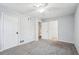 Bedroom featuring gray walls, baseboard trim, a closet, door to the hallway, and ceiling fan at 2248 Bethel Rd, Conyers, GA 30012