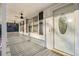 Covered front porch with ceiling fans and a decorative glass front door at 2248 Bethel Rd, Conyers, GA 30012