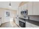 Well-lit kitchen with stainless steel appliances and white cabinets at 2248 Bethel Rd, Conyers, GA 30012
