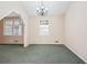 A cozy living room features carpeted flooring and a vintage chandelier at 2248 Bethel Rd, Conyers, GA 30012