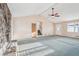 Bright living room featuring a stone fireplace, ceiling fan and stair access at 2248 Bethel Rd, Conyers, GA 30012