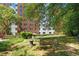 Backyard of building features lush lawn, manicured landscaping, seating and mature shade trees at 2965 Pharr Court South Nw # 1-817, Atlanta, GA 30305