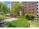 Exterior of building features lush lawn, manicured landscaping, walkway, and patio at 2965 Pharr Court South Nw # 1-817, Atlanta, GA 30305