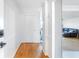 Bright hallway featuring hardwood floors, white walls, and crown molding, leading to living area at 2965 Pharr Court South Nw # 1-817, Atlanta, GA 30305