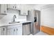 Modern kitchen with stainless steel refrigerator, white cabinets, and updated countertops at 2965 Pharr Court South Nw # 1-817, Atlanta, GA 30305