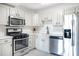 Modern kitchen featuring white cabinetry, stainless steel appliances, and stylish countertops at 2965 Pharr Court South Nw # 1-817, Atlanta, GA 30305