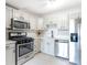 Bright kitchen features stainless steel appliances, white cabinets, and modern countertops at 2965 Pharr Court South Nw # 1-817, Atlanta, GA 30305