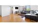 Bright living space boasts hardwood floors, a modern media cabinet, and comfortable sectional sofa at 2965 Pharr Court South Nw # 1-817, Atlanta, GA 30305