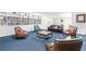 Spacious living room features custom built-in bookshelves, a brown leather sofa, and comfortable seating at 2965 Pharr Court South Nw # 1-817, Atlanta, GA 30305