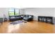 Open living area with hardwood flooring, a large sectional sofa, and views of trees outside window at 2965 Pharr Court South Nw # 1-817, Atlanta, GA 30305