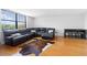 Bright living space features hardwood floors, lots of light from windows, and a comfortable leather sectional sofa at 2965 Pharr Court South Nw # 1-817, Atlanta, GA 30305
