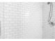 Bright shower features a shower head and tiled walls with bright white subway tiles at 2965 Pharr Court South Nw # 1-817, Atlanta, GA 30305