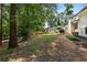 Expansive backyard with mature trees, a grassy lawn, a shed, and a view of the home's exterior at 3331 Doyle Sw Ln, Marietta, GA 30060