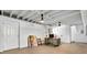 Unfinished basement area featuring exposed ceiling, white painted walls, and access to other areas at 3331 Doyle Sw Ln, Marietta, GA 30060