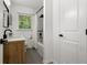 Bathroom featuring a wood vanity, black plumbing fixtures, and shower and tub combo at 3331 Doyle Sw Ln, Marietta, GA 30060