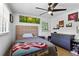 Bedroom featuring a large window, ceiling fan and hardwood floors at 3331 Doyle Sw Ln, Marietta, GA 30060