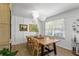 Bright dining room with a wooden table, stylish wicker chairs, and modern pendant lighting creating an inviting atmosphere at 3331 Doyle Sw Ln, Marietta, GA 30060