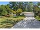 Charming one-story home featuring mature trees, a well-manicured lawn and a concrete driveway leading to an attached garage at 3331 Doyle Sw Ln, Marietta, GA 30060