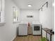 Bright laundry room featuring a washer, dryer, and storage at 3331 Doyle Sw Ln, Marietta, GA 30060