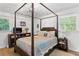 Serene main bedroom with a four-poster bed, soft lighting, and windows providing natural light at 3331 Doyle Sw Ln, Marietta, GA 30060