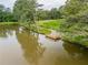 Picturesque view of the lake with wooden dock, offering serene waterfront enjoyment at 3472 Fishpond Cir, Dacula, GA 30019