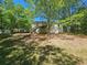 Large backyard view of the house with a wooden deck and shed at 71 Streamview Trl, Douglasville, GA 30134