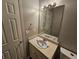 Bathroom featuring vanity with mirror and lighting, and a toilet, all freshly winterized at 71 Streamview Trl, Douglasville, GA 30134