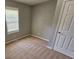 Cozy bedroom with neutral walls, plush carpet, and natural light at 71 Streamview Trl, Douglasville, GA 30134