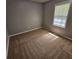 Neutral bedroom features a bright window and carpeting at 71 Streamview Trl, Douglasville, GA 30134