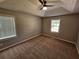 Cozy bedroom with neutral walls, plush carpet, and bright windows at 71 Streamview Trl, Douglasville, GA 30134