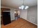 Open dining area with a classic chandelier and view of the staircase at 71 Streamview Trl, Douglasville, GA 30134