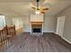 Open living room with hardwood floors, a stone fireplace, and ample natural light at 71 Streamview Trl, Douglasville, GA 30134