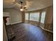 Bright living room featuring hardwood floors, a stone fireplace, and large bay windows at 71 Streamview Trl, Douglasville, GA 30134