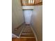 Stairs going to basement with wooden railing and door at the bottom at 71 Streamview Trl, Douglasville, GA 30134