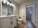 Modern bathroom with a white vanity, black fixtures, and new hardwood floors at 894 Oak Rd, Lawrenceville, GA 30044