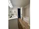 Bright bathroom featuring a double sink vanity and tub at 894 Oak Rd, Lawrenceville, GA 30044
